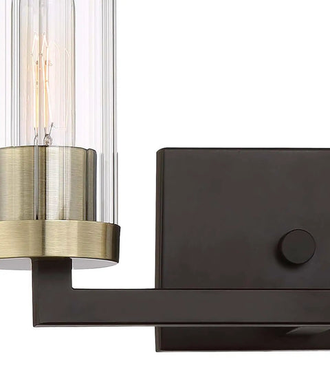 Ainsley Court Vanity Bath Light Two Light Fixture in Aged Kinston Bronze with Brushed Brass Highlights, ribbed glass shade close-up.