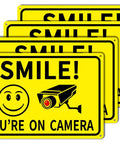 4 Pack Smile Youre On Camera Signs 8x12 Rust Free Aluminum Outdoor Video Surveillance Signs with smiley face and camera graphic