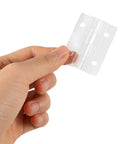 Hand holding one of Two Sets of Mini Acrylic Hinges for Wooden Boxes and Crafts, showcasing size and transparency.