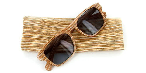 Top Tier Faux Wood Bifocal Reading Sunglasses With Plus 1.50 Power and Full Sun Blocking Spring Hinge Frames on a textured surface.