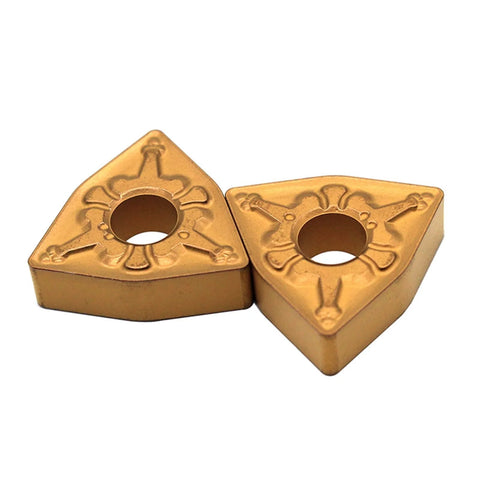 Two gold carbide turning inserts, WNMG080408, for steel turning on CNC lathes.