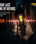 Ultra Slim EDC Flashlight With 800 Lumen Output held in hand, activating 80dB siren in dark alley, person in background