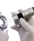 USB Digital Microscope With True 20x To 50x And 200x Optical Zoom 0.3MP 640 By 480 Image, 30 FPS Video, Measurement Tools In Inches And Millimeters, WF-20 Ready, MicroTouch For Easy Image Capture. Gloved hands inspect a ball bearing.