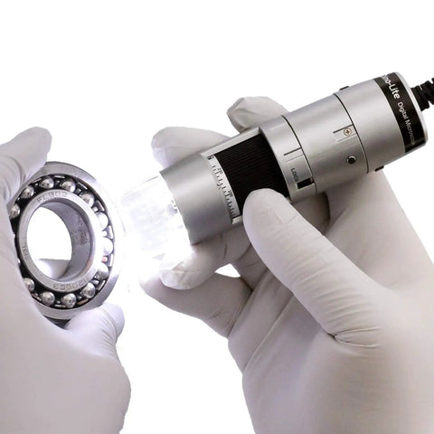 USB Digital Microscope With True 20x To 50x And 200x Optical Zoom 0.3MP 640 By 480 Image, 30 FPS Video, Measurement Tools In Inches And Millimeters, WF-20 Ready, MicroTouch For Easy Image Capture. Gloved hands inspect a ball bearing.