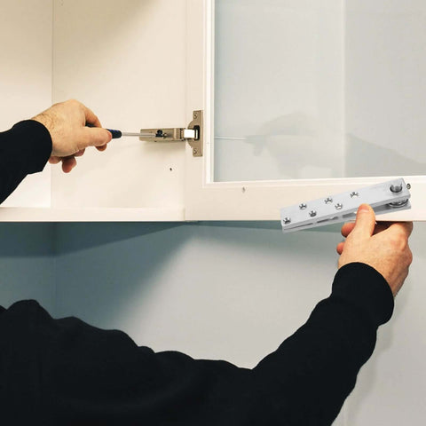 Installation of invisible concealed door hinge with 360 degree pivot for secret bookcase doors, showing hardware.