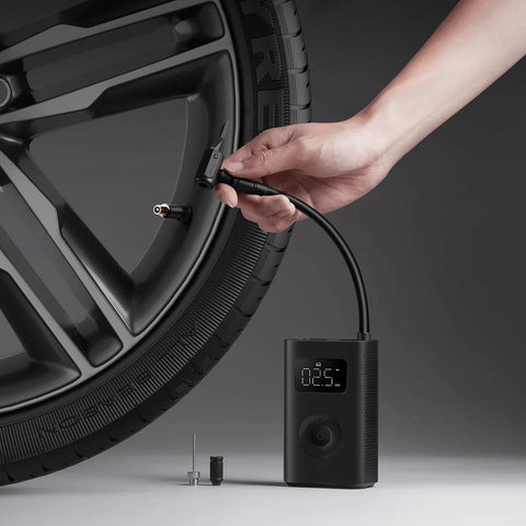 Using Portable Electric Air Compressor 2 With 150 Psi, Fast Inflate For Cars, Trucks And Bikes on a car wheel