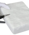 Ceramic fiber blanket, 12x24x2 in, white; Amazon brand, being cut with a knife for high-temperature insulation.
