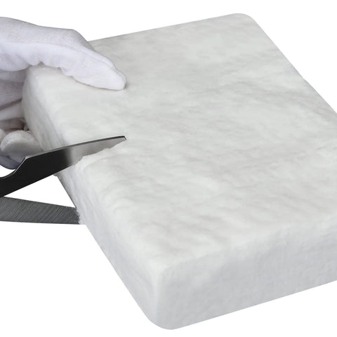Ceramic fiber blanket, 12x24x2 in, white; Amazon brand, being cut with a knife for high-temperature insulation.