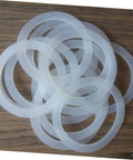 5 Pack Silicone Sealing Rings Replacement Gaskets For Coffee Pot Lids Espresso Pots And Canning Jars on wood surface