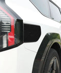 Fresh Glossy Black EV Charging Port Cover Trim Compatible With Kia EV9 2024 2025 2026 on white car side.