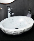 Durable Modern Oval Marble Vessel Sink Handcrafted From Real Natural Stone Above Counter Bathroom Vanity Bowl on black countertop.