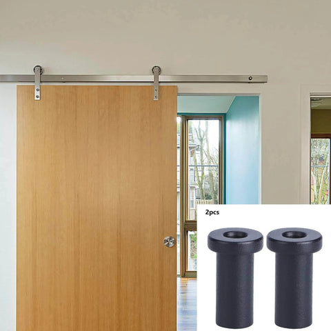 Built Tough Bottom Spacers For Sliding Barn Doors, Matte Black Wall Spacers With Door Shaft Pins, Pack Of 2 shown next to installed door.