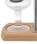 Slick Vintage Balance Syphon Coffee Maker Set Featuring Heavy Duty Stainless Steel And Borosilicate Glass Vacuum Brewing System For A Dope Home Barista Morning Perk Ritual close-up of glass and wooden base.