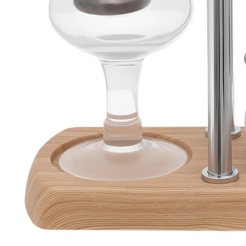 Slick Vintage Balance Syphon Coffee Maker Set Featuring Heavy Duty Stainless Steel And Borosilicate Glass Vacuum Brewing System For A Dope Home Barista Morning Perk Ritual close-up of glass and wooden base.