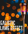 Solar Powered Tiki Torch Lantern Zapper With Realistic Flickering Flame against a backdrop of blurred lights