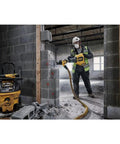 High Power 60V Brushless Cordless Chipping Hammer With SDS Max Chuck And Rear Handle Setup For Rapid Concrete Tear Out in use by a worker.