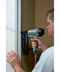 Person using 16-Gauge Straight Finish Nailer Kit With Tool-Free Depth-Of-Drive Adjustment, Jam Release, And Durable Motor, Drives 1-Inch To 2-1/2-Inch FN Style Nails, Go-To For Trim, Molding, And Fine Finish Projects on door frame