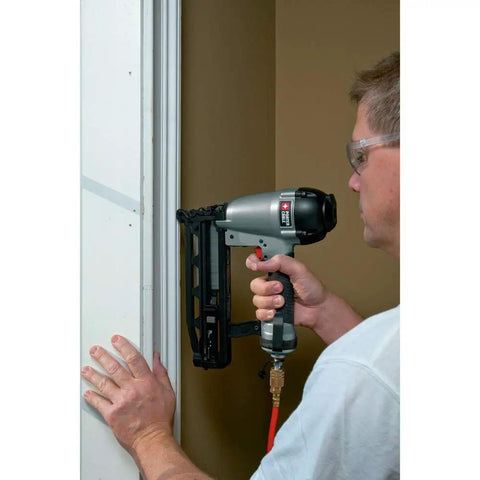 Person using 16-Gauge Straight Finish Nailer Kit With Tool-Free Depth-Of-Drive Adjustment, Jam Release, And Durable Motor, Drives 1-Inch To 2-1/2-Inch FN Style Nails, Go-To For Trim, Molding, And Fine Finish Projects on door frame