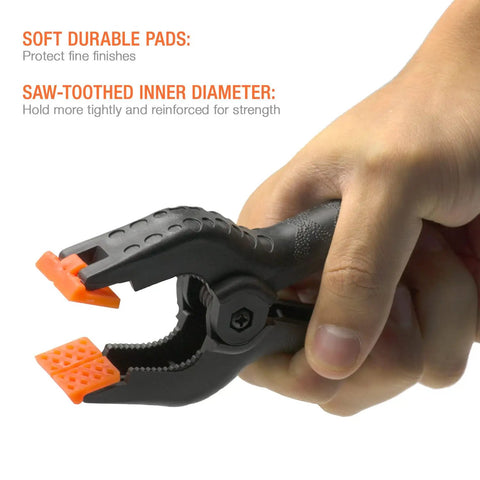 Person holding a Heavy Duty 4.5 Inch Nylon Spring Clamp, showing orange movable tips and rugged plastic body with textured grip.