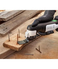 Eco Friendly Cordless Oscillating Multi Tool With 12V Max Muscle And Rapid Blade Swap Mechanism For Cutting Sanding Scoring And Home Ripping Jobs Around The Garage Or Yard in use on wood with nails.