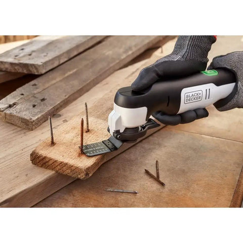 Eco Friendly Cordless Oscillating Multi Tool With 12V Max Muscle And Rapid Blade Swap Mechanism For Cutting Sanding Scoring And Home Ripping Jobs Around The Garage Or Yard in use on wood with nails.