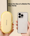 Grab And Go Travel Sewing Kit With Round Case Emergency Repair Gear in yellow next to a mobile phone for size comparison.