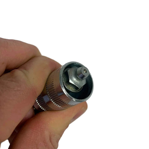 90 degree grease coupler for tight spaces held in hand