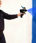 Heavy Duty PU Foam Spray Gun With Air Purge And Slick Self Cleaning Point Zero Zero Four Nozzle spraying blue paint on a wall.