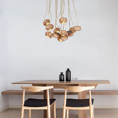 Handmade Solid Wood 19 Light Pendant Chandelier With Drop Dead Gorgeous Art Flower Petals And Smart Led Tech Generating Heavy Ambient Vibes For Your Interior Setup hanging above a wooden dining table