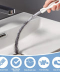 Heavy Duty Drain Cleaning Brush To Kick Stubborn Clogs To The Curb Flexible Pipe Snake Tool being used in a kitchen sink.
