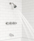 Three Handle Tub And Shower Faucet With Metal Verve Knob Handles In Polished Chrome For A Slick Bath Upgrade Includes 5 Hole Installation Valve And Cartridge Shower Arm And Flange CALGreen And CEC Water Saving installed on white tile