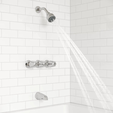 Three Handle Tub And Shower Faucet With Metal Verve Knob Handles In Polished Chrome For A Slick Bath Upgrade Includes 5 Hole Installation Valve And Cartridge Shower Arm And Flange CALGreen And CEC Water Saving installed on white tile