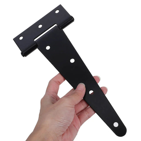 Hand holding a Heavy Duty 8 Inch Black Iron Door Hinge With Extended T Shape Design And Slotted Bearing for easy adjustment.