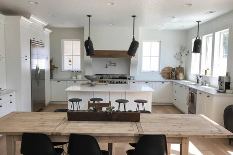 Modern kitchen featuring a white interior, wooden dining table, grey bar stools, and Pro Level Reactive Water Based Interior Wood Stain.
