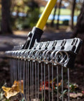 Heavy-Duty 55-Inch Fiberglass Rake With A 21-Inch Steel Tined Head for de-thatching and landscaping, close-up of metal tines.