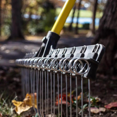 Heavy-Duty 55-Inch Fiberglass Rake With A 21-Inch Steel Tined Head for de-thatching and landscaping, close-up of metal tines.