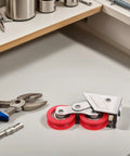 Heavy Duty Sliding Door Roller With Dual Nylon Wheels And Tough As Nails Stainless Steel Core on a workbench with tools.