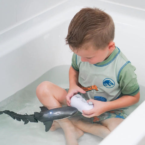Child playing in bathtub with Remote Control Shark Pool Toy For Kids With Lights And Water Spray 2.4GHz, Dual Motors