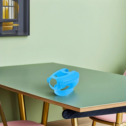 Pro Grade Pigeon Injection Holder For Easy Medicine Feeding on a table, blue plastic bird holder, hollow out design shown