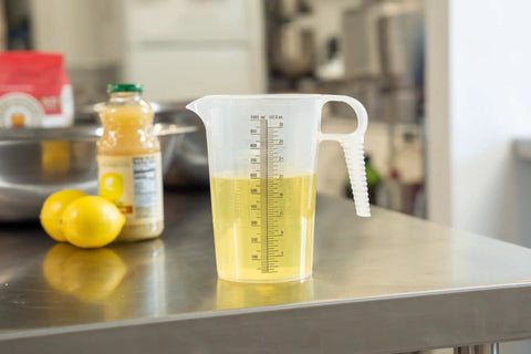 32oz One Quart Measure Pitcher With Conversion Chart, Extra Strong Food Grade Polypropylene, BPA Free, Microwave And Dishwasher Safe, Translucent Easy Pour Design For Cooking, Home Hobbies, Oils And Fluids, Spa Chemicals, filled with yellow liquid