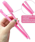 Hand holding a pink cordless hair trimmer with comb teeth for easy styling. Perfect for DIY trims at home.