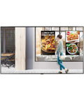 Forty Nine Inch Digital Signage Display Rock Solid Fanless WebOS Smart Panel 2500 Nit Brightness glare-free display showcasing food menus in storefront.