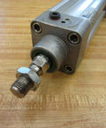 Bosch Rexroth Double Acting Cylinder 523-111-050-0 with visible 3/4 inch shaft and 1/4 NPT port on wooden surface