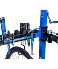 Deluxe Tool And Work Tray For Repair Stands PRS TT 2 holding tools on blue bike stand with ergonomic design for maintenance.