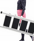 Person carrying a foldable telescopic ladder, showcasing Pro Grade Electric Attic Staircase With Remote Control And Foldable Telescopic Ladder For Smooth Loft Access Built Like A Tank Aluminum Frame Crushes Heavy Loads Your New Daily Driver.
