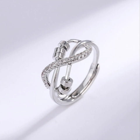 Silver-tone knot fidget ring with bead spinning for stress relief and focus, featuring adjustable design and calming benefits.