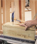 Using California Framer Hammer 19 Oz Smooth Face With Nail Starter on wooden block, showcasing heavy duty framing tool in action.