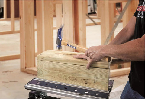 Using California Framer Hammer 19 Oz Smooth Face With Nail Starter on wooden block, showcasing heavy duty framing tool in action.