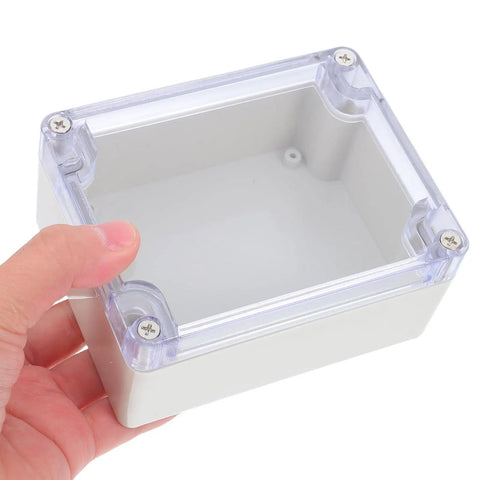 Sturdy White Plastic Junction Box With Clear Dustproof Cover For Electrical Project Setups held by a hand, showing interior space.