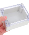 Heavy Duty Waterproof Plastic Junction Box With Tough Cover For Electrical Projects, held in hand, with transparent lid for monitoring.